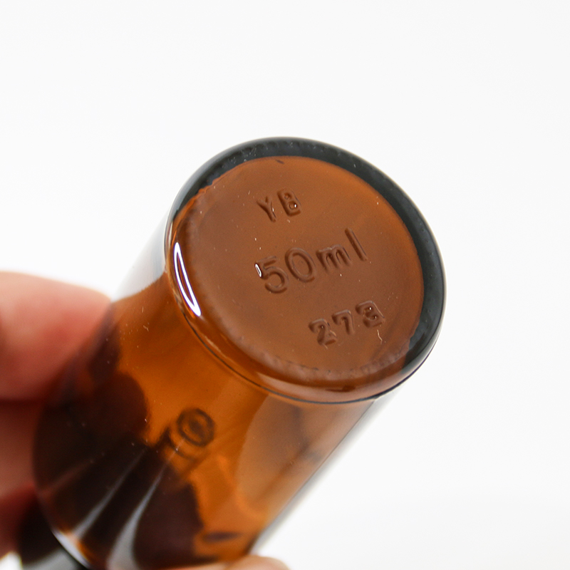 close up of a opaque glass bottle packaging for serums with medicine dropper closure 01